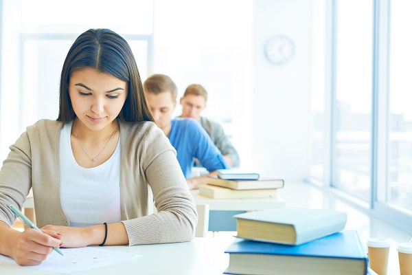 Portrait of pensive student carrying out test at lesson